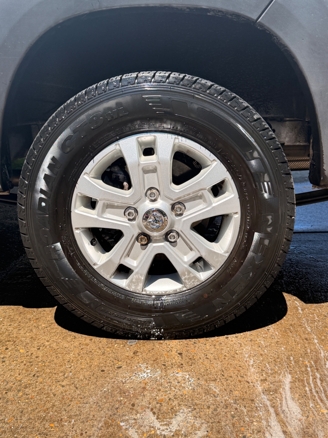 Same truck wheel cleaned with tire dressed after detailing